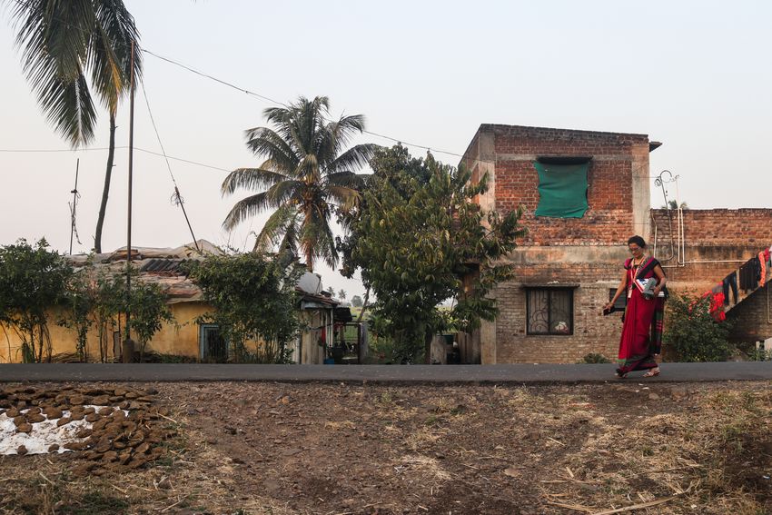 A community healthcare worker walks down the road carrying an informational booklet about gestational diabetes. A community healthcare worker walks down the road carrying an informational booklet about gestational diabetes.