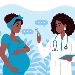 A pregnant woman is talking to a doctor.
