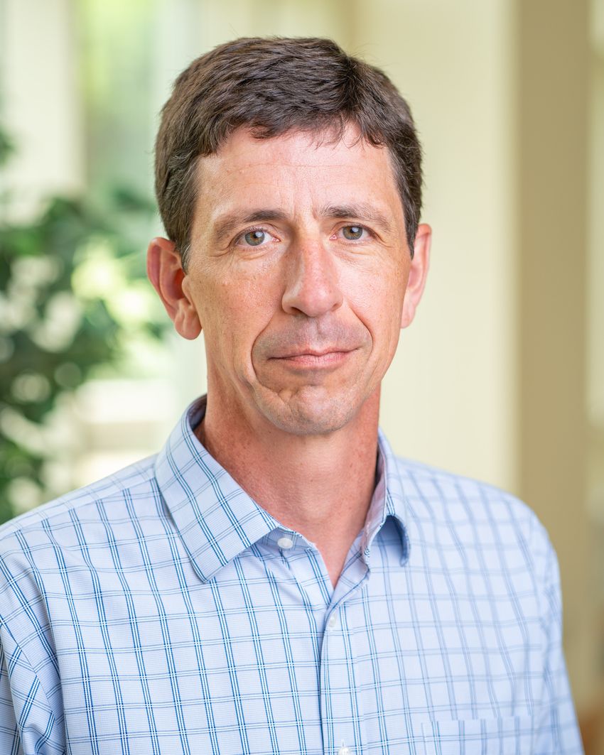 A photograph of Kenneth Belanger wearing a blue shirt