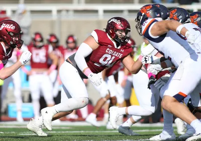 A picture of Zachary Pelland playing American football, signifying head impacts during the sport that were linked with gut microbiome changes.