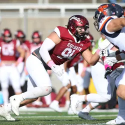 A picture of Zachary Pelland playing American football, signifying head impacts during the sport that were linked with gut microbiome changes.
