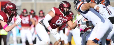 A picture of Zachary Pelland playing American football, signifying head impacts during the sport that were linked with gut microbiome changes.