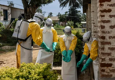 Members of the Ebola response team, Médecins Sans Frontières, disinfect their gloves as they respond to the Ebola outbreak in the Democratic Republic of the Congo in May 2026.