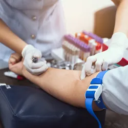 A nurse is taking a patient's blood test, signifying the NAD+ biomarkers in blood.