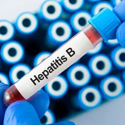 A blue-gloved hand holding a blood draw tube with a label ‘hepatitis B.’