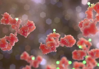 Stylized 3D rendering of antibody-drug conjugate molecules with glowing payload particles