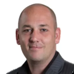 Guy German smiles in a headshot.