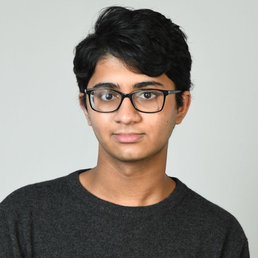 Photograph of Pavan Subramani, a high school student. He has dark hair and black glasses and is wearing a dark T-shirt.