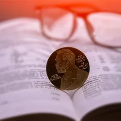 Nobel prize medal on an open book, indicating the super-resolution microscopy Nobel prize.