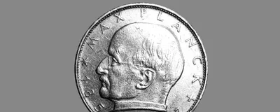 Max Planck’s profile is shown on one side of silver-colored coin.