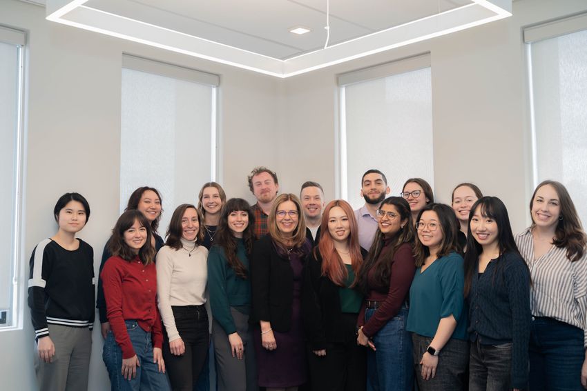 A group of people standing in a room.
