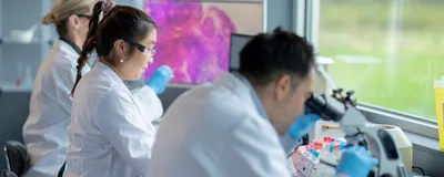 Researchers examine biological samples in an oncology lab