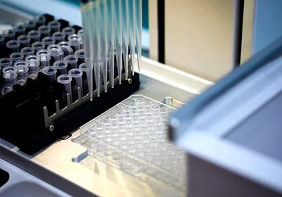 Automated liquid handler with a 96-well plate for sample or library preparation.