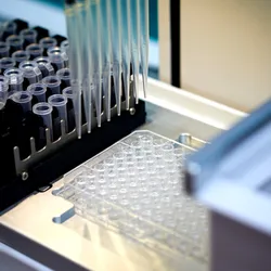Automated liquid handler with a 96-well plate for sample or library preparation.