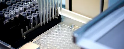 Automated liquid handler with a 96-well plate for sample or library preparation.