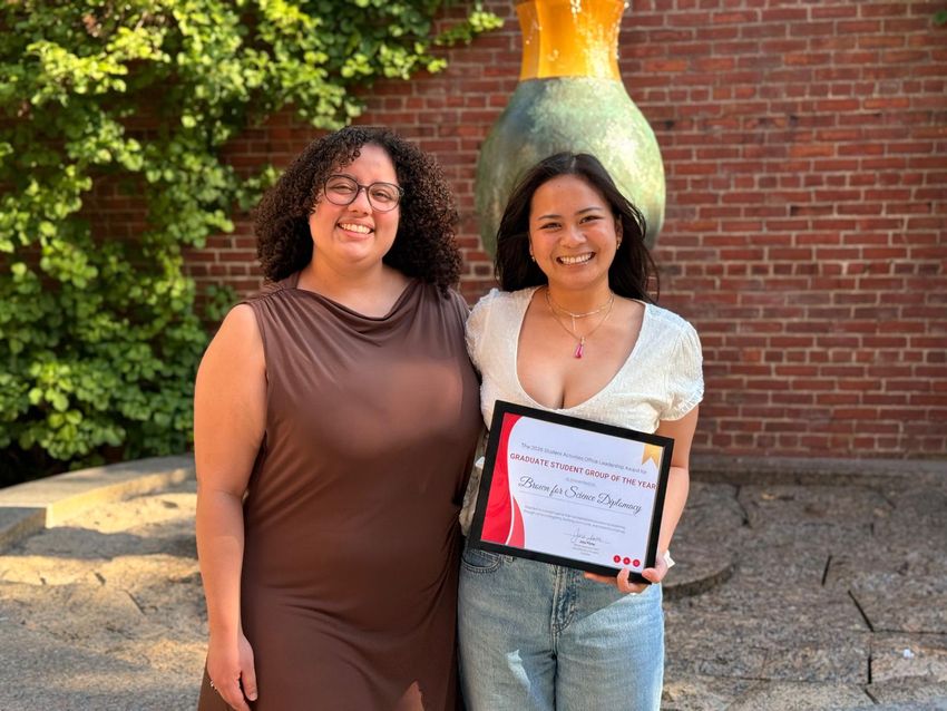 Image of Melanie Ortiz Alvarez de la Campa (left) and Mai Huynh (right) holding an award.