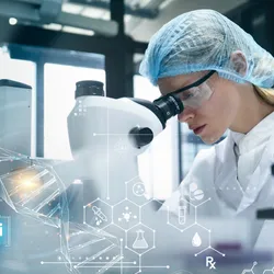 Scientist using a microscope in a modern laboratory with digital data visualizations.