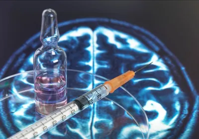 A medical syringe with an ampule and brain scan background signifying BCG which reduced markers of Alzheimer’s disease. 