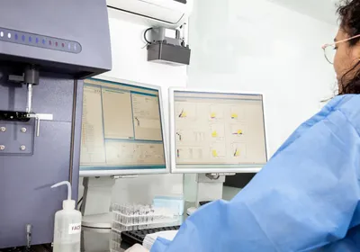 Scientist analyzing data from a flow cytometry experiment