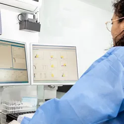 Scientist analyzing data from a flow cytometry experiment
