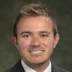 Wesley Kufel smiles in a headshot photo.