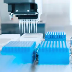 Automated liquid handling system with a multichannel pipette positioned above microplates for library preparation workflow.