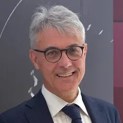 Giovanni Straffelini wears a suit and glasses in a headshot photo.