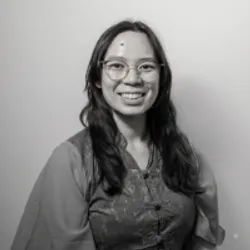 black and white photo of Sharon Dong smiling in a button-up blouse