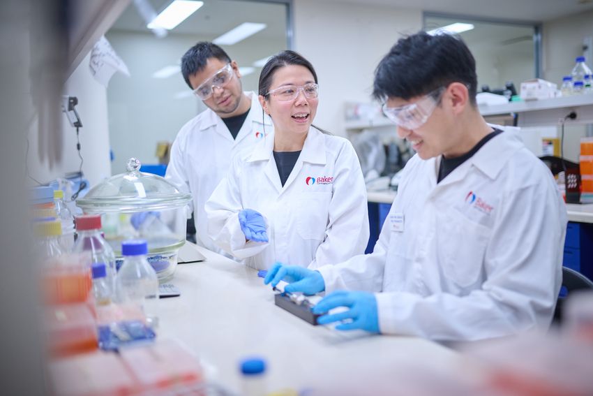 Image of three researchers. Xiaowei Wang is in the middle.