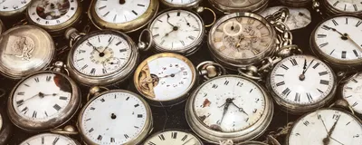 Retro styled image of old scratched and run down pocket watches, signifying biological age kits that predict epigenetic aging.