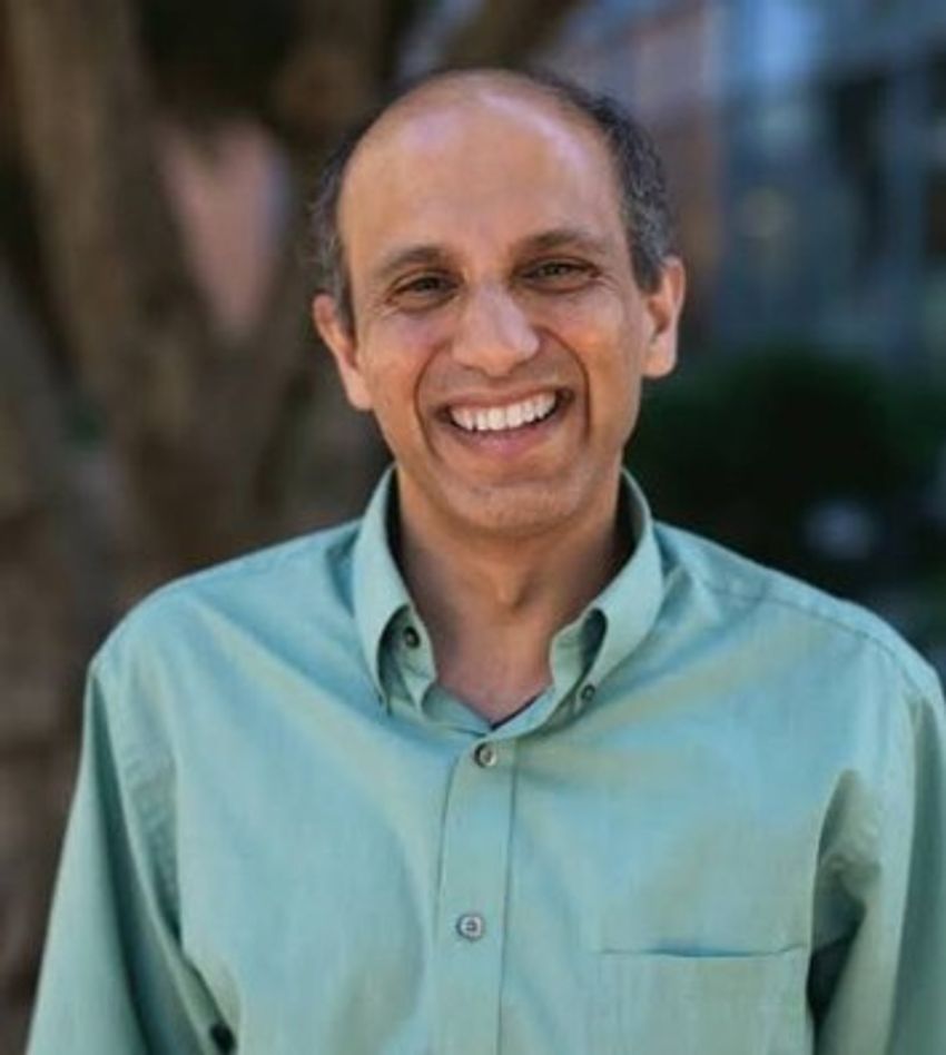 A man wearing a green shirt smile. A man wearing a green shirt smile.
