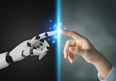 A robot finger and a human finger touch.