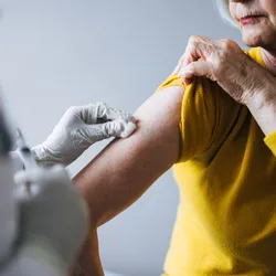 A woman receiving a vaccine. 