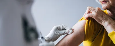 A woman receiving a vaccine.