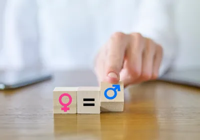 A finger moves blocks signifying symbols of female and male sexes.