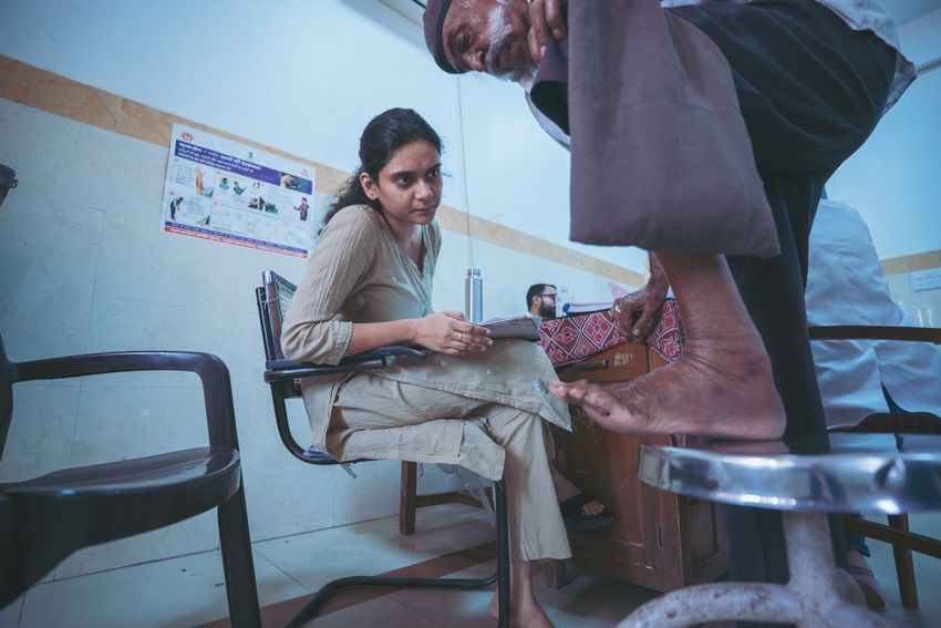 A doctor examines a man for mycetoma.