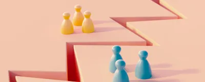 A crevasse between two groups of blue and yellow colored pawns on a pink background.