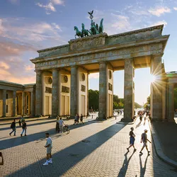 A view of the Brandenburg Gate in Berlin at sunset.