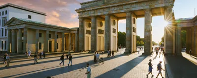 A view of the Brandenburg Gate in Berlin at sunset.