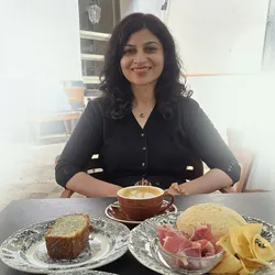 Image of Meenakshi Prabhune seated at a table.