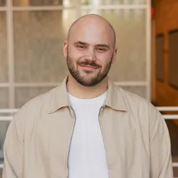 Dirk Hackenberger wears a light-colored jacket and white shirt in a headshot photo.