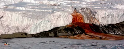 A blood red waterfall, Blood Falls, is shown as it exits Taylor Glacier and flows into Lake Bonney in Antarctica.