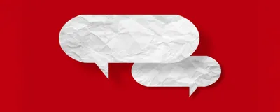 White speech bubble crumpled paper isolated on red background, indicating the debates surrounding the use of AI in Nikon Small World Photography competition.