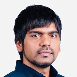 Shiladitya Banerjee wears a blue shirt in a headshot photo.
