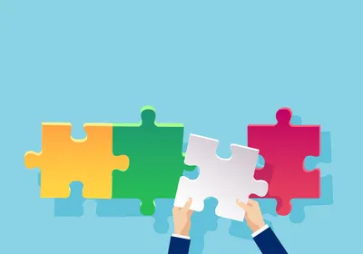 A photo of a yellow, green and pink puzzle piece assembled in a line with a gap between the green and pink piece on a blue background. A pair of hands lefts a white puzzle piece to fill the gap in the puzzle. 